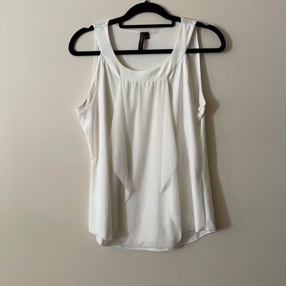 Cream/white blouse with front flowy fabric detail.